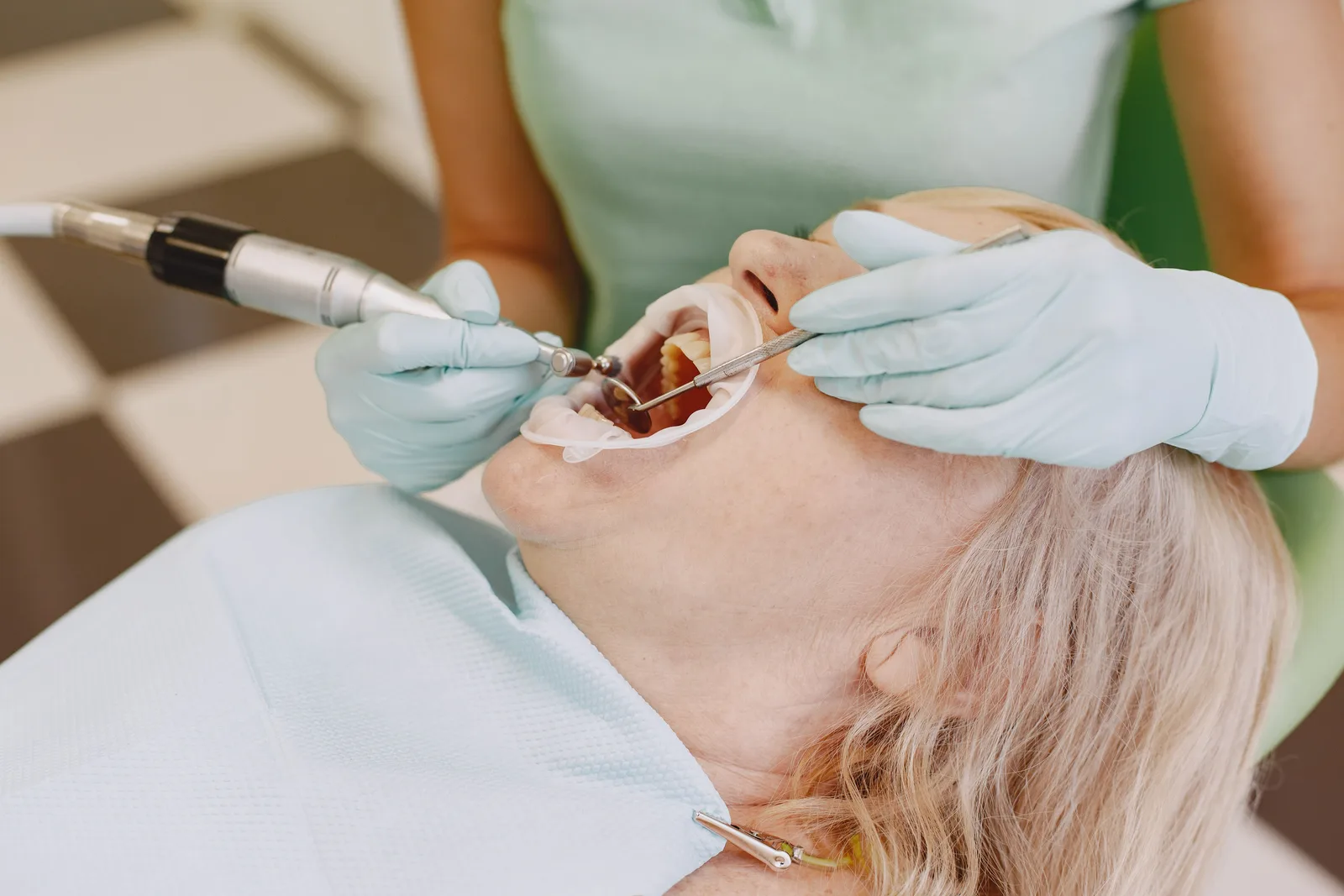 Tooth prepared for a crown with a dental handpiece, shown while covering Implant Lifespan in Virginia Beach