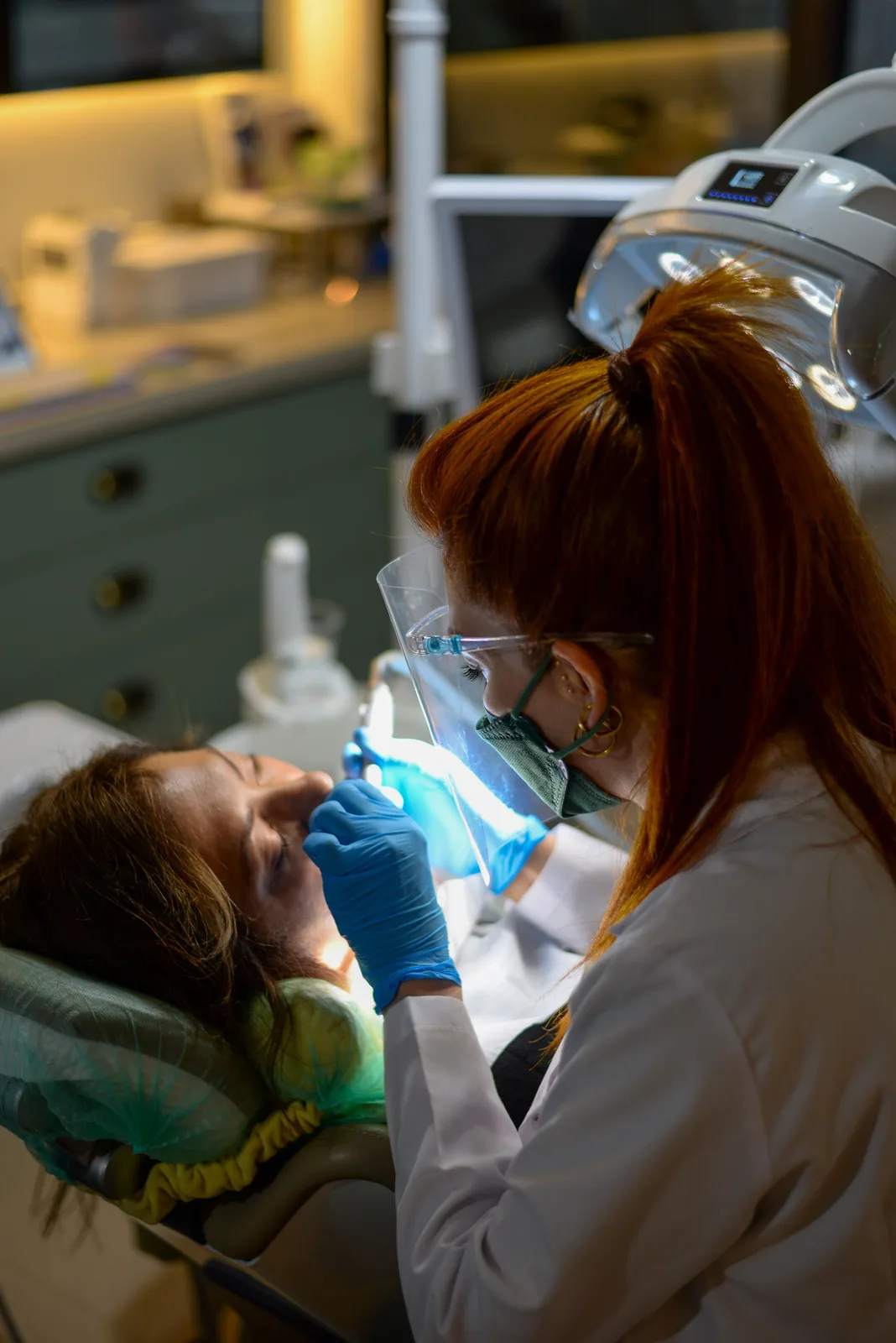 Curing light used during chairside treatment, shown while covering Dental Implant Cost in Virginia Beach