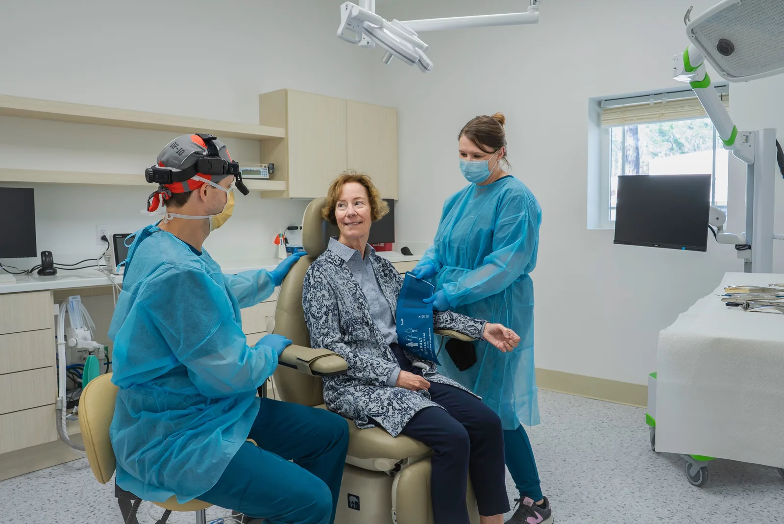 Dental team with a patient in the operatory, alongside the Single Tooth Implant explanation in Virginia Beach