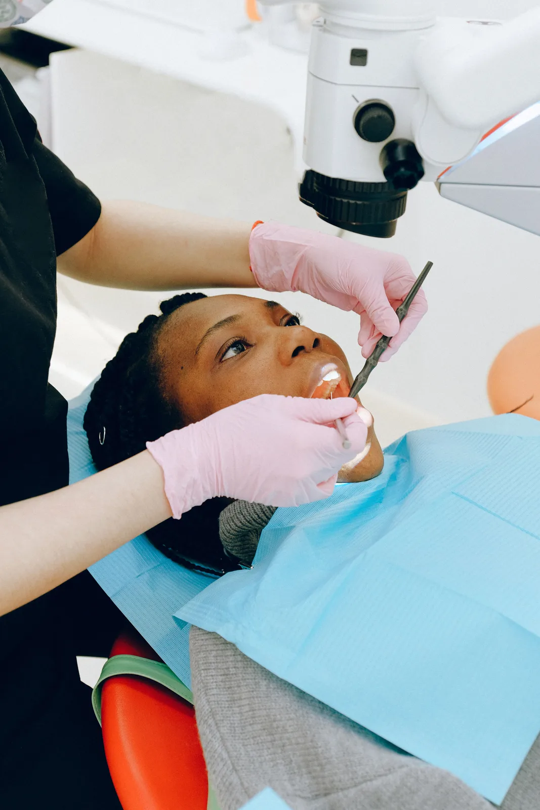 Microscope assisted dental treatment, shown while covering Front Tooth Implant in Virginia Beach