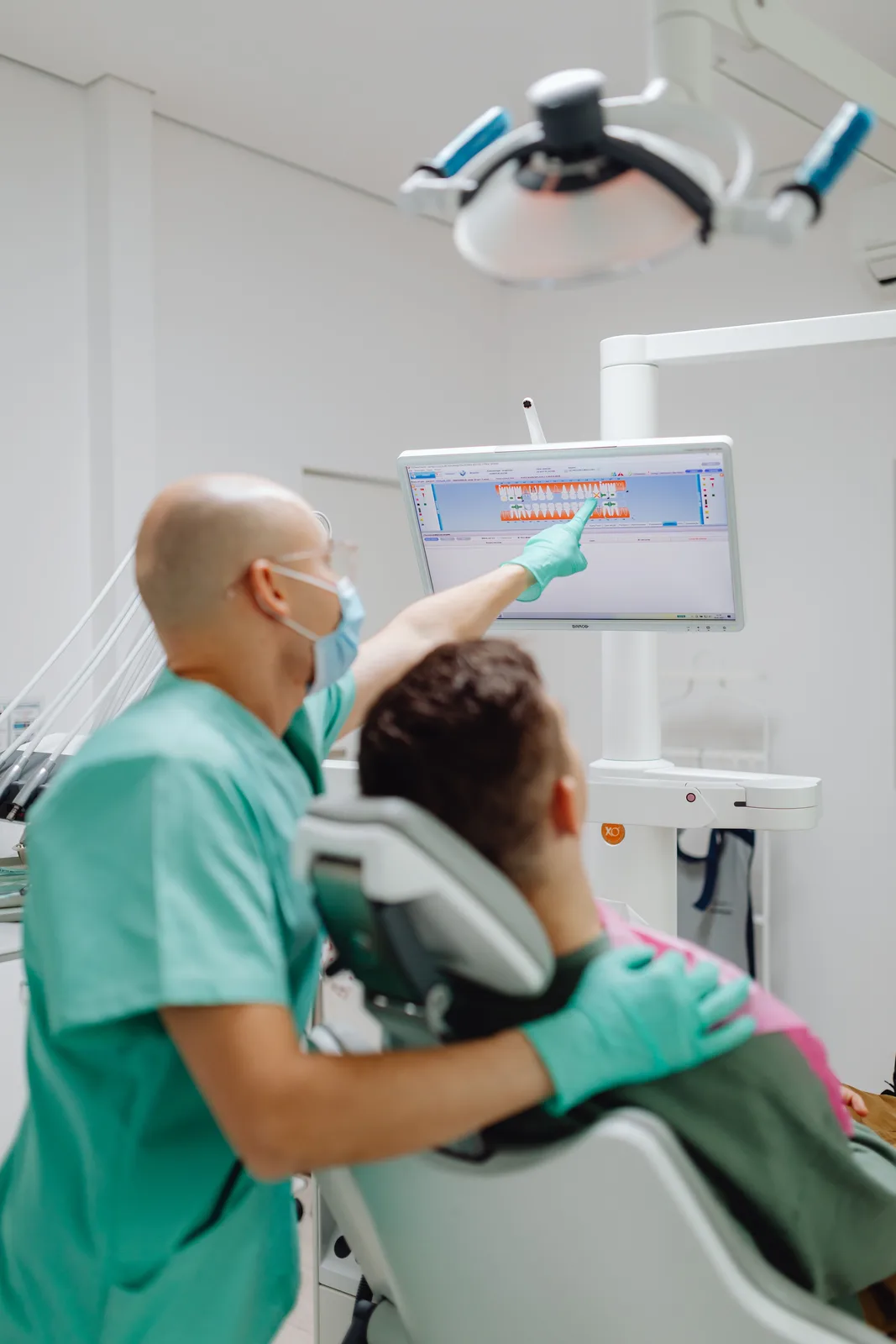 Reviewing the treatment plan on the chairside screen, alongside the Dentures Vs Implants explanation in Virginia Beach