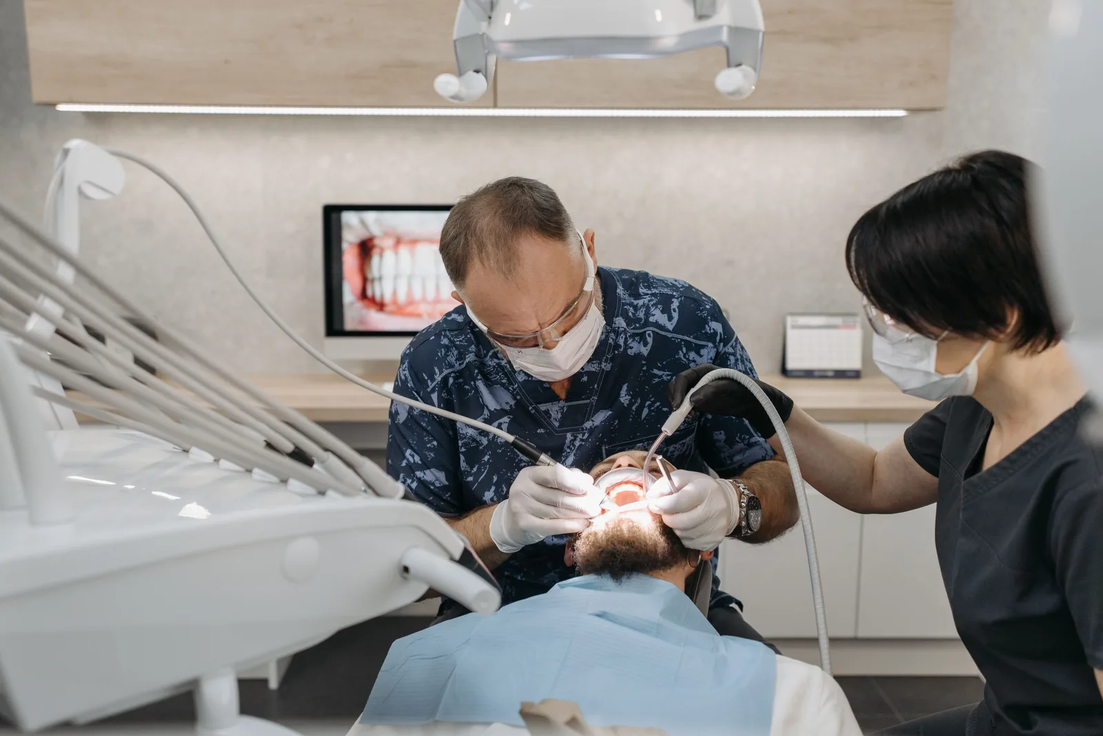 Dentist and assistant working together during treatment, referred to in the All-on-6 Implants section for Virginia Beach